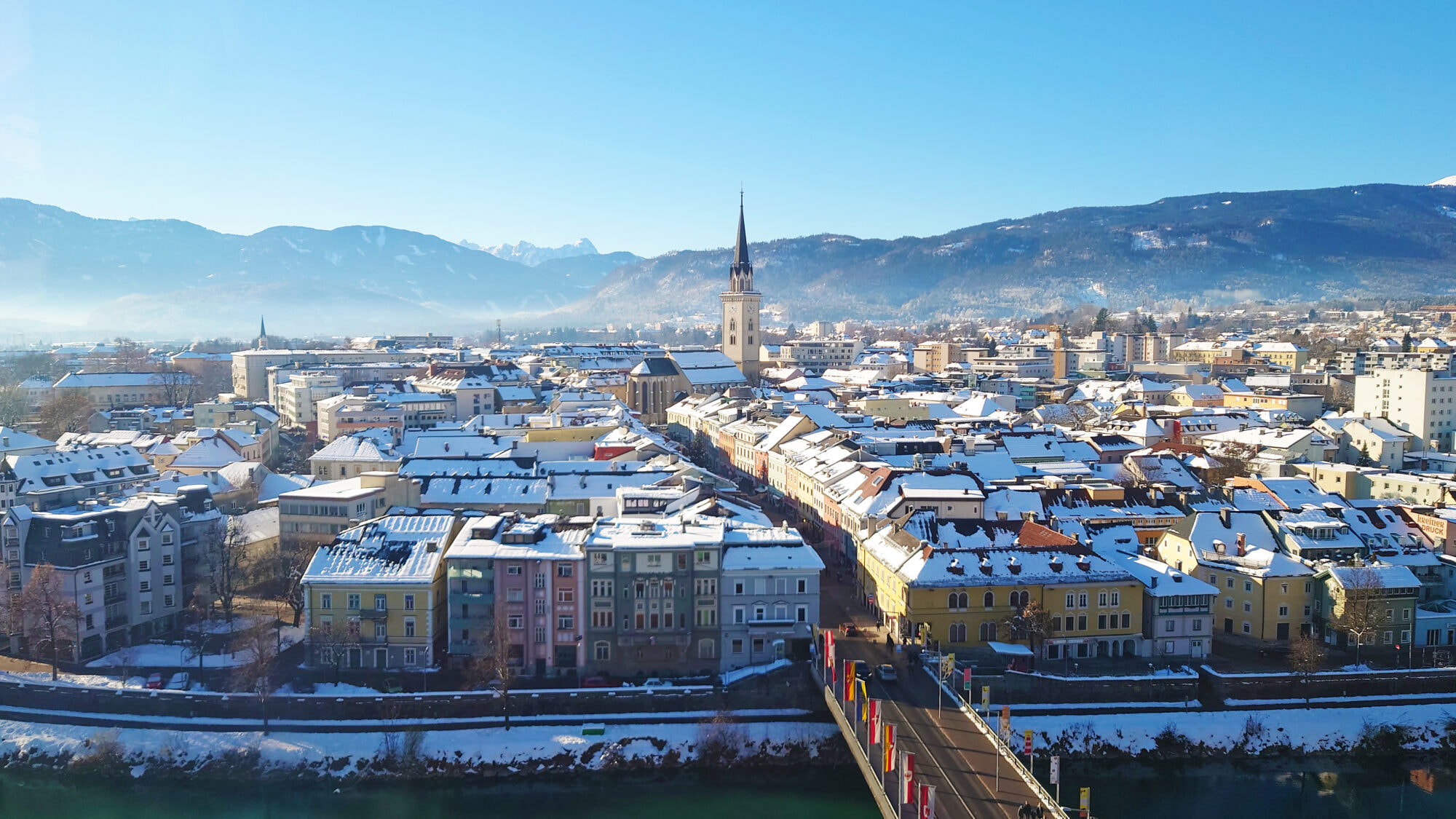 Panorama view of the city Villach in Carinthia, Austria. Big city with beautiful church and mountains on the background. Taken in the winter.